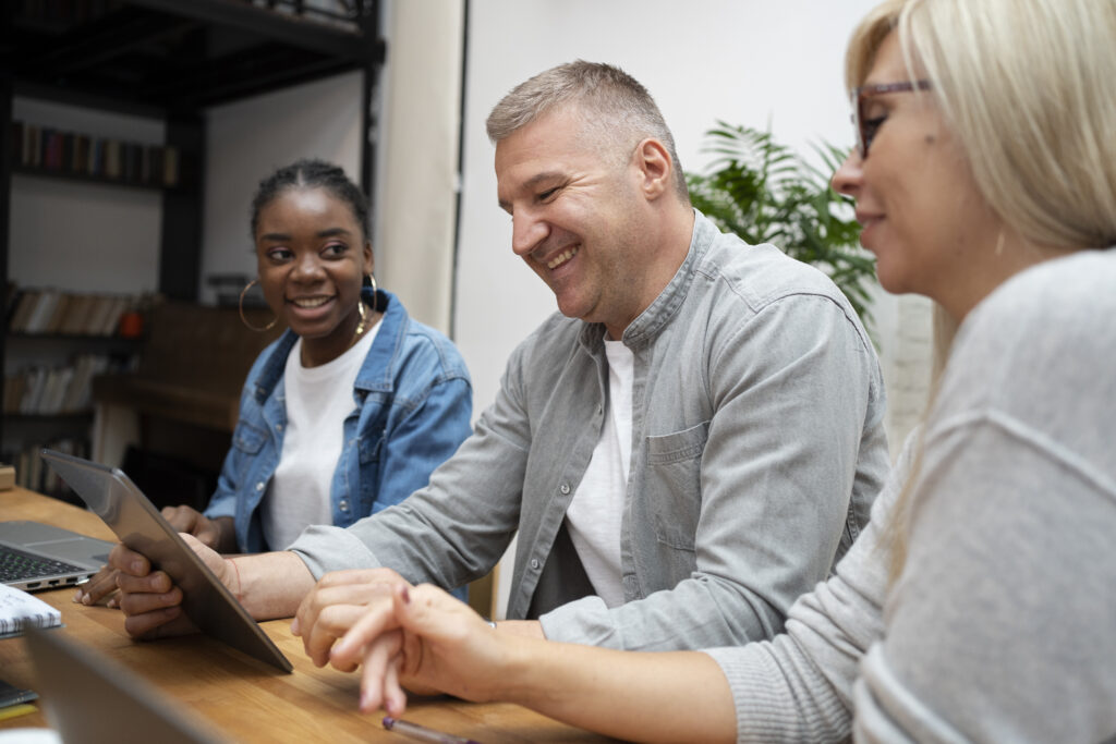 Happy people in an office collaborating.